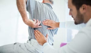 Doctor checking patient spine problem
