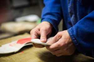 A man molding a pair of custom orthotics