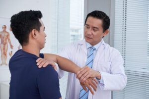 Physician Examining Sportsman at orthopedic care
