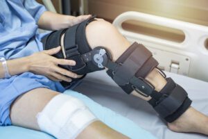Asian woman patient with bandage compression knee brace support injury