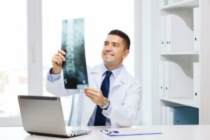 Spine Doctor Looking at Patient Spine X-ray