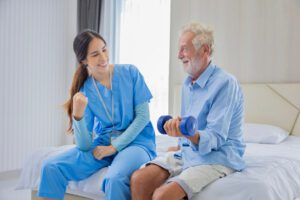 Professional nurse at the hospital bandaging the hand with a medical bandage for a woman patient