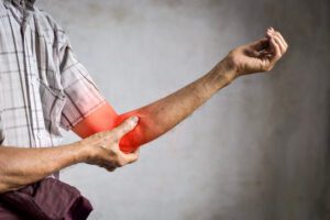 Golfer's elbow pain in the elbow joint of a senior man.
