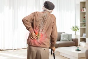 an elderly man with a back pain